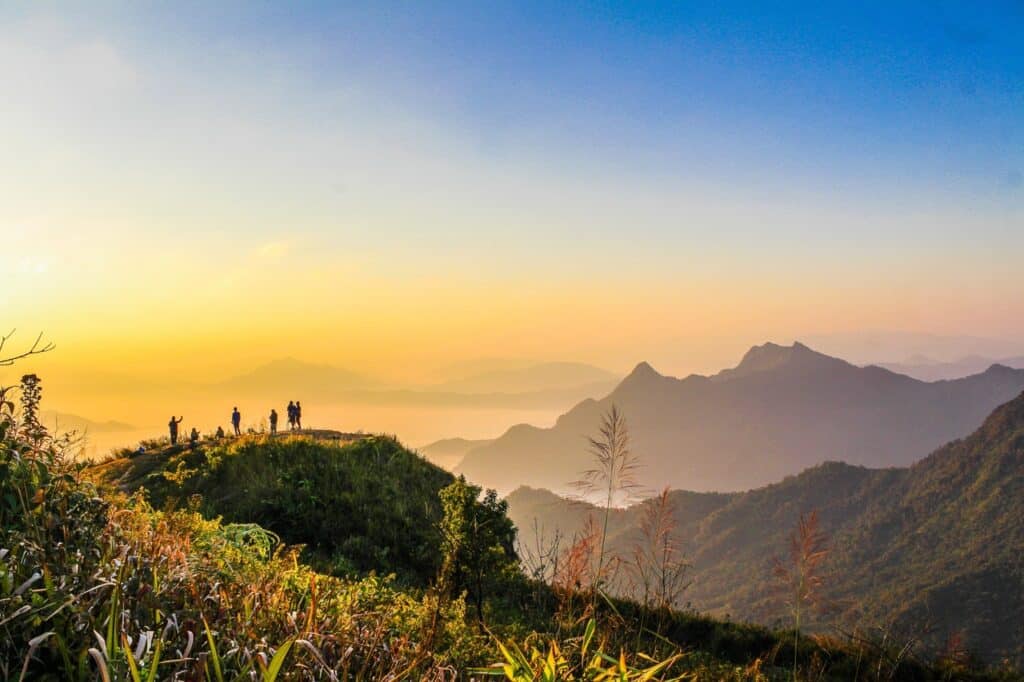 photo of people standing on top of mountain near grasses 733162.jpg